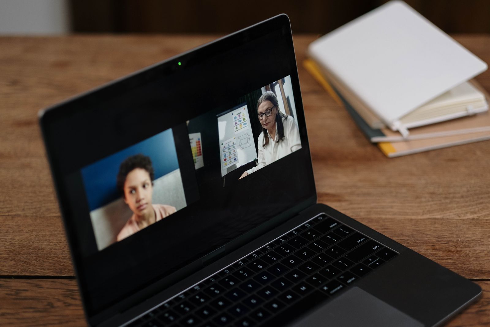 Online class on a laptop with a teacher and student visible